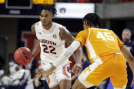 Auburn guard Allen Flanigan (22) brings the ball in as Tennessee guard Keon Johnson (45) defends during the first half of an NCAA basketball game Saturday, Feb. 27, 2021, in Auburn, Ala. (AP Photo/Butch Dill)