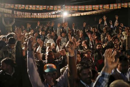 Supporters of India's ruling Bharatiya Janata Party (BJP) cheer as Sanjeev Balyan (unseen), a federal agriculture minister and a member of BJP, addresses a by-election campaign rally in Muzaffarnagar district in the northern state of Uttar Pradesh, India, February 9, 2016. REUTERS/Anindito Mukherjee