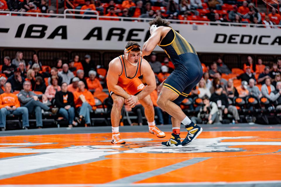 Oklahoma State's Konner Doucet, left, is 12-3 in the heavyweight class for the Cowboys this season.