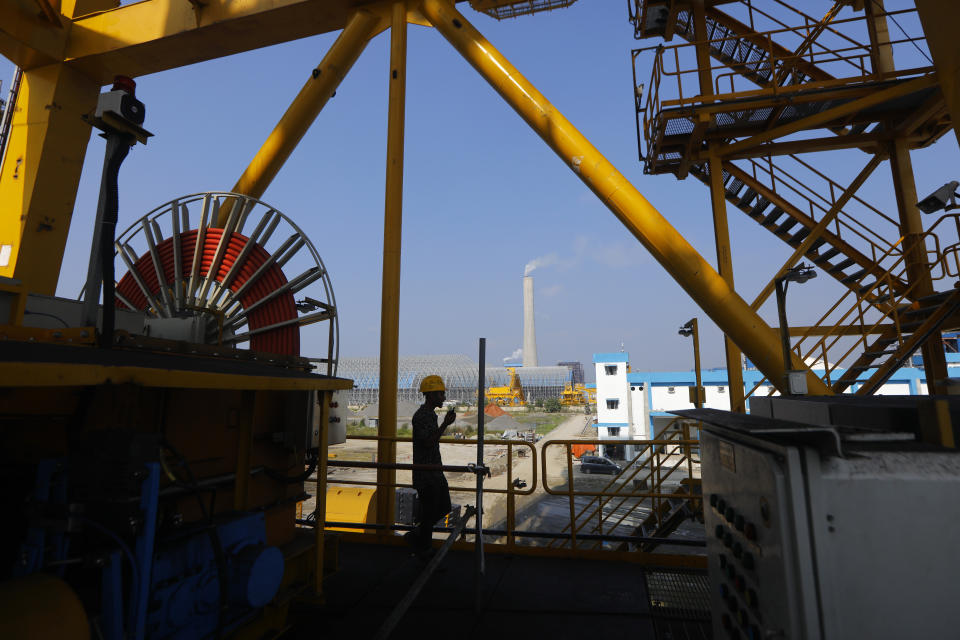 A worker talks on the walkie talkie at the Maitree Super Thermal Power Project near the Sundarbans, the world's largest mangrove forest, in Rampal, Bangladesh, Monday, Oct. 17, 2022. A power plant will start burning coal as part of Bangladesh’s plan to meet its energy needs and improve living standards, officials say. (AP Photo/Al-emrun Garjon)