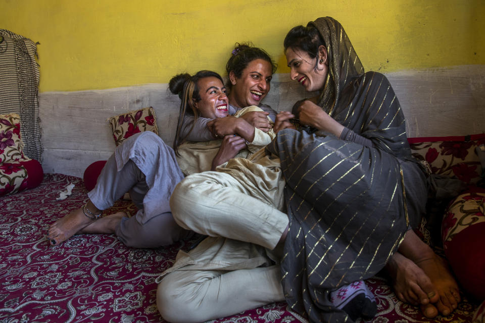 A transgender Kashmiri Khushi Mir, left, relaxes with friends at the end of a meeting of community members in the outskirts of Srinagar, Indian controlled Kashmir, Friday, June 4, 2021. Khushi, along with four young boys, have begun a volunteer group to distribute food kits to the transgender community. (AP Photo/ Dar Yasin)