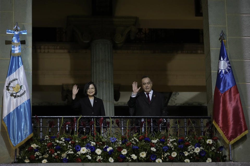Taiwan's President Tsai Ing-wen, left, and Guatemala's President Alejandro Giammattei, wave from a balcony at the National Palace in Guatemala City, Friday, March 31, 2023. Tsai is in Guatemala for an official three-day visit. (AP Photo/Moises Castillo)