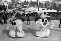 Snowmen, mascots of the 1976 Winter Olympics in Innsbruck, appear in Kitzbühel, Austria, Jan. 28, 1975, during World Cup downhill skiing events. (AP Photo)