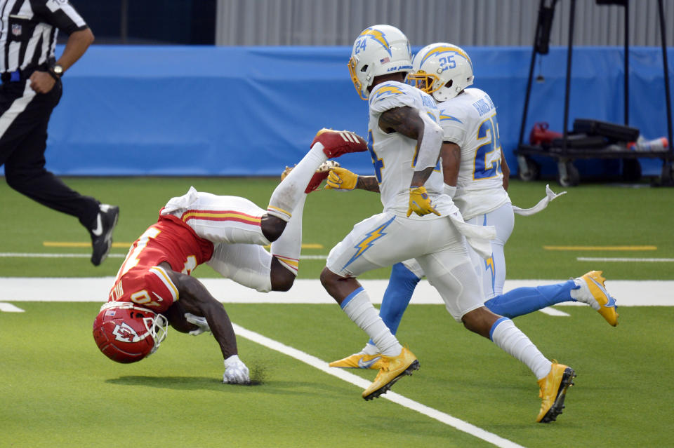 Kansas City Chiefs wide receiver Tyreek Hill, left, tumbles as he makes a touchdown reception against the Los Angeles Chargers during the second half of an NFL football game Sunday, Sept. 20, 2020, in Inglewood, Calif. (AP Photo/Kyusung Gong)