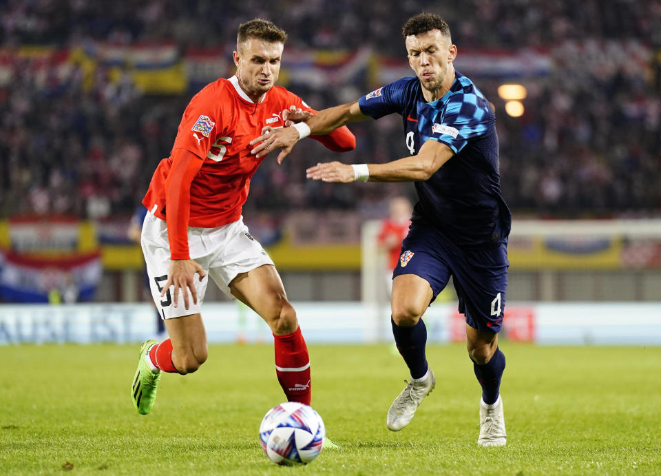 El austriaco Stefan Posch, izquierda, disputa el balón con el croata Ivan Perisic durante un partido entre Austria y Croacia por la Liga de Naciones de la UEFA en el estadio Ernst Happel en Vienna, Austria, el domingo 25 de septiembre de 2022. (AP Foto/Florian Schroetter, Archive)