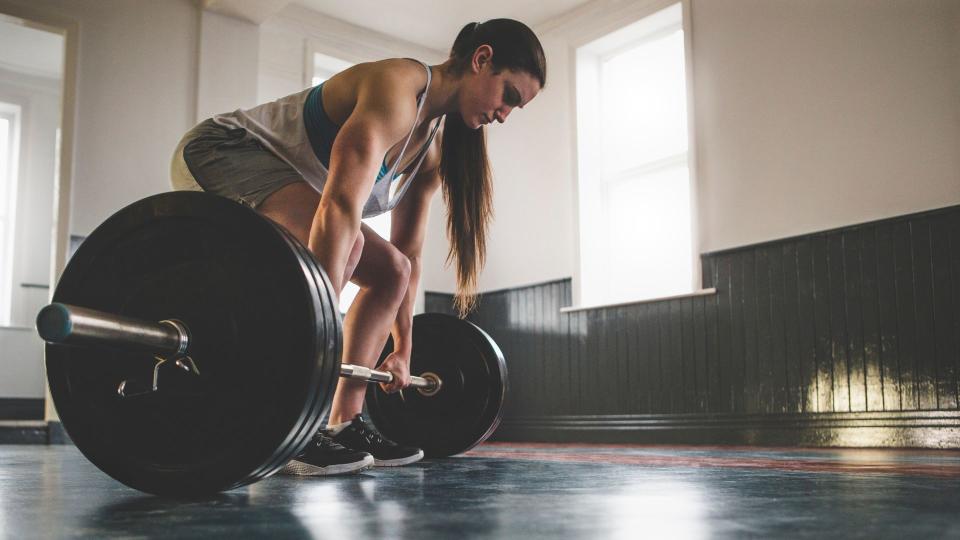 Woman performing a conventional deadlift