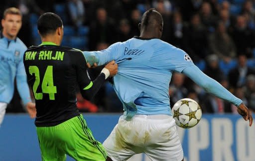 Mario Balotelli (right) is pulled back in the penalty area by Ricardo van Rhijn during the Champions League match between Manchester City and Ajax at The Etihad Stadium last week