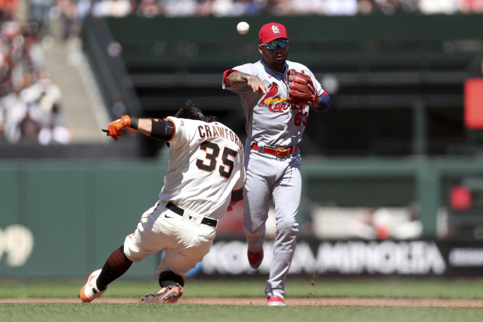 St. Louis Cardinals' Edmundo Sosa, right, throws to first as San Francisco Giants' Brandon Crawford, left, slides into second on a double play hit by Jaylin Davis during the second inning of a baseball game in San Francisco, Monday, July 5, 2021. (AP Photo/Jed Jacobsohn)