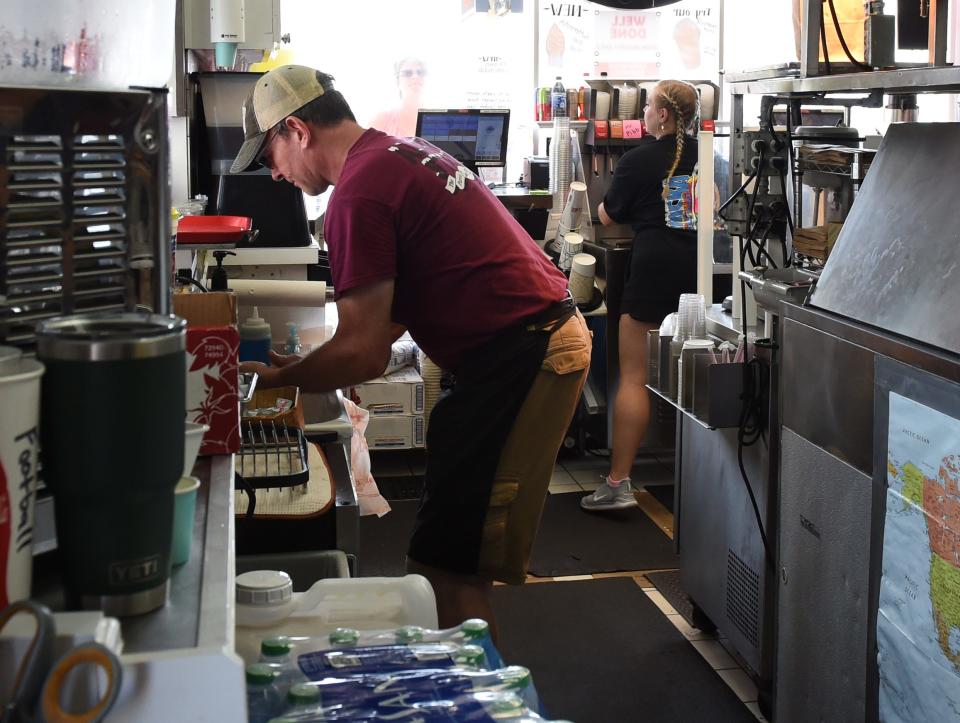 Workers complete food orders at the Alaska Stand Thursday, Aug. 26, 2021, in Ocean City, Maryland.