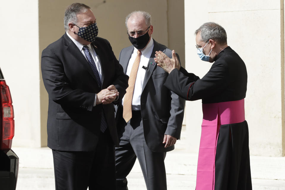 U.S. Secretary of State Mike Pompeo, left, is greeted by Monsignor Joseph Murphy, head of Vatican protocol, after meeting Vatican Secretary of State Cardinal Pietro Parolin, at the Vatican, Thursday, Oct. 1, 2020. Pompeo is meeting Thursday with top Vatican officials, a day after tensions over U.S. opposition to the Vatican's China policy spilled out in public. (AP Photo/Andrew Medichini)