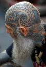 <p>A hand-tapping tattoo artist’s own body art is seen on his head at the London Tattoo Convention, in London, Britain, Sept. 23, 2017. (Photo: Peter Nicholls/Reuters) </p>