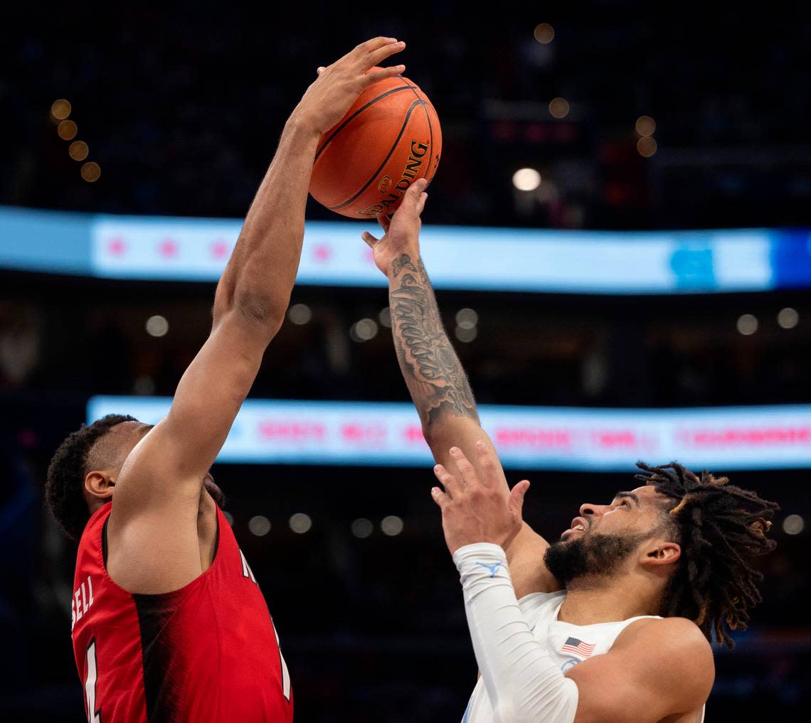 N.C. State’s Casey Morsell (14) blocks a shot by North Carolina’s R.J. Davis (4) during the second half during the ACC Men’s Basketball Tournament Championship at Capitol One Arena on Saturday, March 16, 2024 in Washington, D.C.