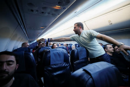 Armenians celebrate during a flight from Kiev, Ukraine, to Yerevan, Armenia, after Armenian Prime Minister Serzh Sarksyan resigned following almost two weeks of mass street protests, April 23, 2018. REUTERS/Gleb Garanich