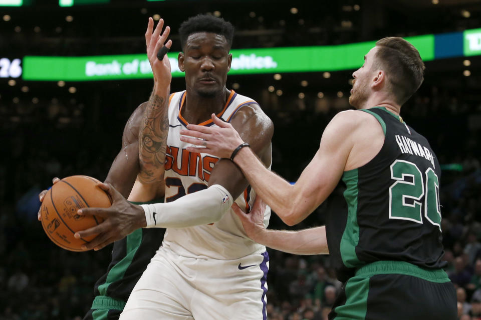 Phoenix Suns center Deandre Ayton, center, is fouled by Boston Celtics forward Gordon Hayward, right, during the second half of an NBA basketball game, Saturday, Jan. 18, 2020, in Boston. (AP Photo/Mary Schwalm)