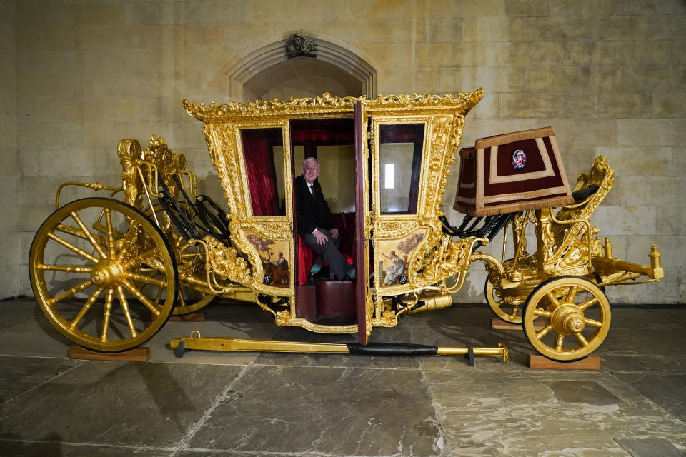 Britain's Speaker of the House of Commons Lindsay Hoyle sits in the Speaker's State Coach as it returns to Westminster, ahead of the coronation of Britain's King Charles III, in London, Sunday, April 30, 2023. The gilded coach, which was last seen in the historic Westminster Hall in 2005, will be on display once again from 2 May to the Autumn, to commemorate the crowning of King Charles III. (AP Photo/Alberto Pezzali)