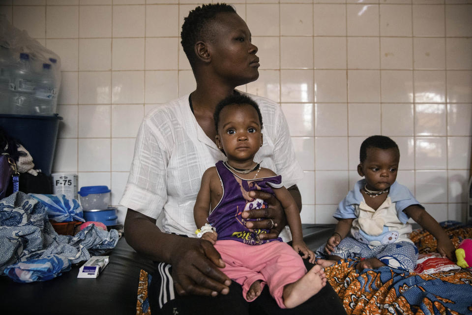 FILE- In this April 15, 2022 file photo, malnourished children wait for treatment in the pediatric department of Boulmiougou hospital in Ouagadougou, Burkina Faso. The U.N. is warning that 18 million people in Africa’s Sahel region face severe hunger in the next three months. Two U.N. agencies are citing the impacts of war in Ukraine, the coronavirus pandemic, climate-induced shocks and rising costs – and warning that people may try to migrate out of the affected areas. (AP Photo/Sophie Garcia, File)