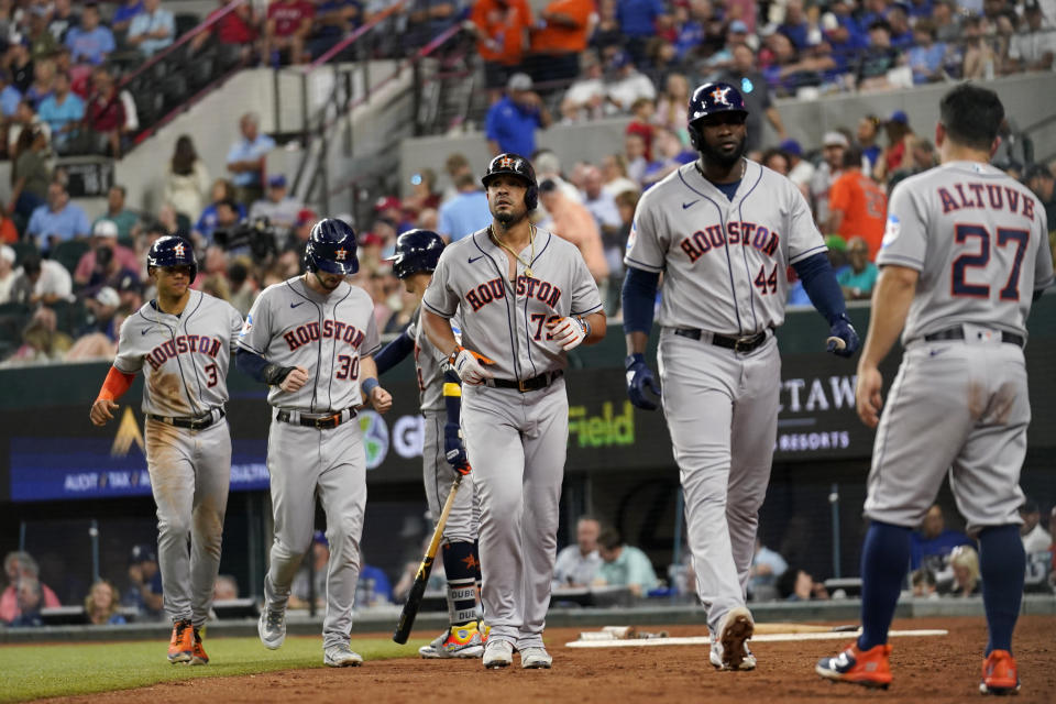 Houston Astros' Jose Altuve (27) waits to congratulate Jose Abreu (79) after Abreau hit a grand slam that also scored Jeremy Pena (3), Kyle Tucker (30) and Yordan Alvarez (44) in the third inning of a baseball game, Wednesday, Sept. 6, 2023, in Arlington, Texas. (AP Photo/Tony Gutierrez)