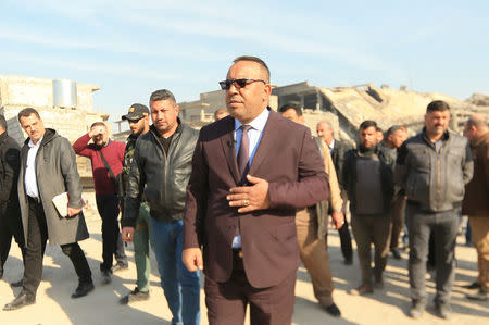 Abdelsattar al-Hibbu, municipality chief of Mosul, tours a neighbourhood with members of his team in Mosul, Iraq, January 10, 2018. REUTERS/Ari Jalal/Files