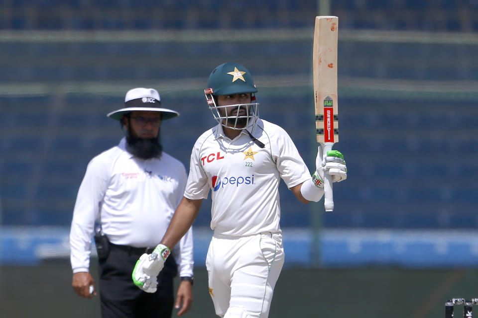 Pakistan's Babar Azam, front, celebrates after completing 150 runs on the fifth day of the second test match between Pakistan and Australia at the National Stadium in Karachi Pakistan, Wednesday, March 16, 2022. (AP Photo/Anjum Naveed)