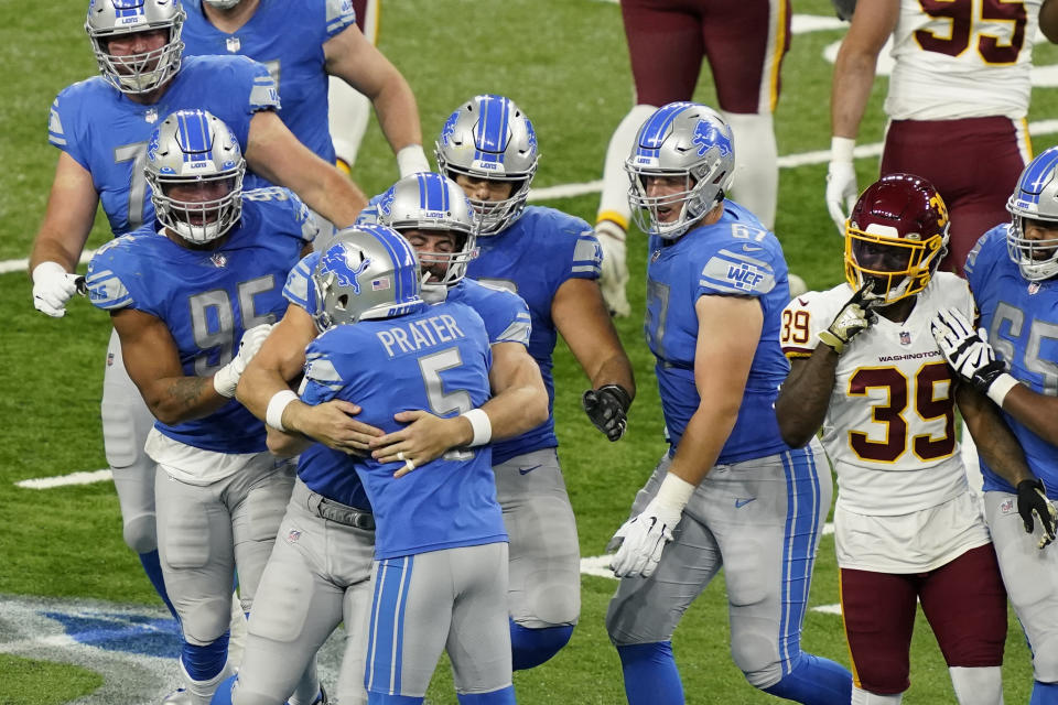 Teammates hug Detroit Lions kicker Matt Prater (5) after his winning field goal in the closing seconds during the second half of an NFL football game against the Washington Football Team, Sunday, Nov. 15, 2020, in Detroit. (AP Photo/Carlos Osorio)