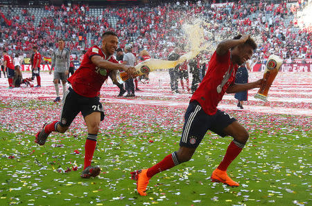 Soccer Football - Bundesliga - Bayern Munich v VfB Stuttgart - Allianz Arena, Munich, Germany - May 12, 2018 Bayern Munich's Corentin Tolisso and Kingsley Coman as they celebrate winning the Bundesliga REUTERS/Michael Dalder