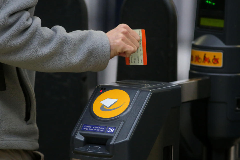 A commuter uses his ticket to exit the platform at Waterloo station, in central London on January 2, 2018. - As the price of an average ticket rose by 3.4 percent on January 2, 2018, rail passengers travelling on the first working day of 2018 are hit with the biggest fare rise in five years. (Photo by Daniel LEAL-OLIVAS / AFP) (Photo by DANIEL LEAL-OLIVAS/AFP via Getty Images)