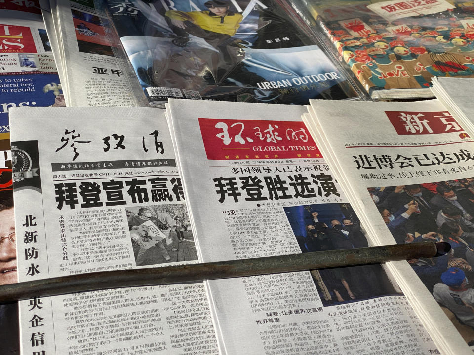 Newspaper front-page with the headlines "Biden wins" are displayed at newsstand on Beijing, China, Monday, Nov. 9, 2020. As Asia comes to terms with the reality of a Joe Biden administration, relief and hopes of economic and environmental revival jostle with needling anxiety and fears of inattention. (AP Photo/Ng Han Guan)