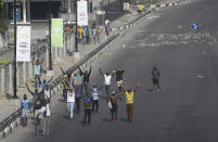 People demonstrate on the street to protest against police brutality in Lagos, Nigeria, Wednesday Oct. 21, 2020. After 13 days of protests against alleged police brutality, authorities have imposed a 24-hour curfew in Lagos, Nigeria's largest city, as moves are made to stop growing violence. ( AP Photo/Sunday Alamba)