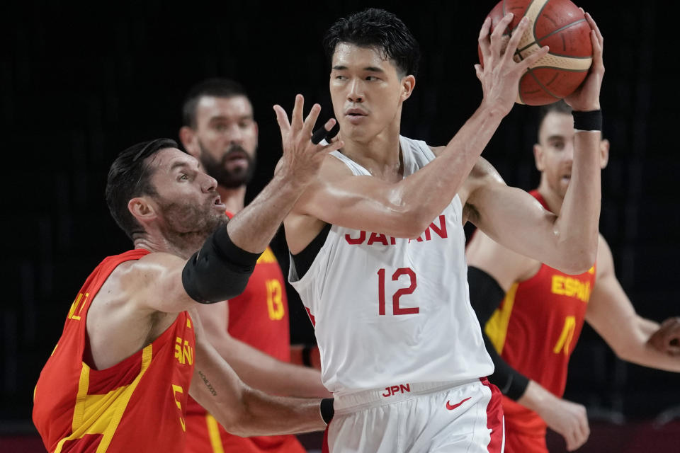 Japan's Yuta Watanabe (12) is defended by Spain's Rudy Fernandez (5) during a men's basketball preliminary round game at the 2020 Summer Olympics in Saitama, Japan, Monday, July 26, 2021. (AP Photo/Eric Gay)