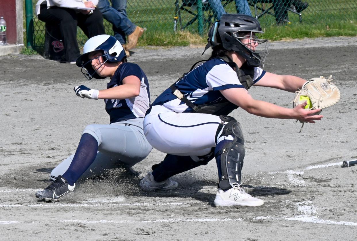 Molly Reino of Sturgis slides into home ahead of the tag by Monomoy catcher AJ Gates.