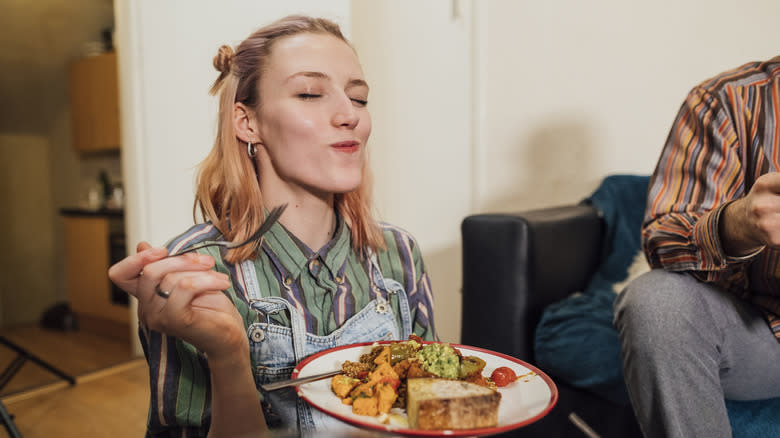 Person enjoying a bite of food