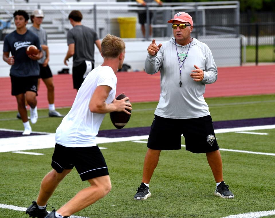 Alan Wartes, former offensive coordinator for Hardin-Simmons University from 1990 - 2010, instructs a participant in his Air It Out Passing Camp Thursday.