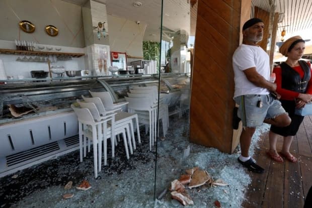 Israelis stand outside a restaurant that was attacked the previous night in rioting in the Mediterranean city of Bat Yam last Thursday.