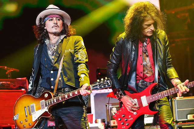 <p>Jim Dyson/Getty</p> Johnny Depp and Joe Perry of Hollywood Vampires perform at The O2 Arena in London, England.