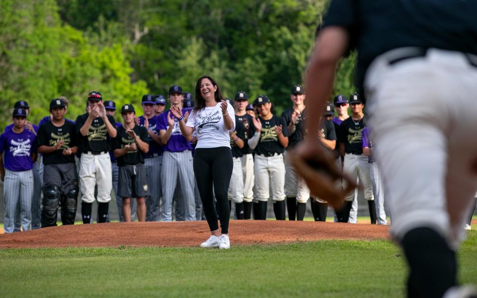 Minde Reinhart throws out the first pitch in honor of the Rex and Brody Foundation before the Buchholz and Gainesville High School game, Thursday, April 14, 2022, at Buchholz High School, in Gainesville, Florida. Reinhart set up the Foundation in her sons' honor after they were tragically killed by their father in a murder-suicide in May 2021. The boys were very active in baseball, and the Foundation was established to help fund youth baseball players who might not be able to afford it. It also helps fund scholarships and facility upgrades for local ball fields.