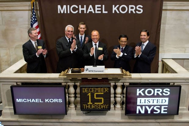 Michael Kors rings the opening bell at the New York Stock Exchange on Dec. 15, 2011