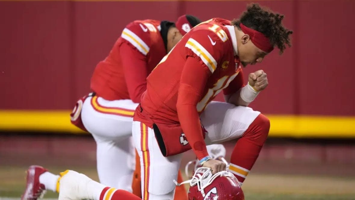 Kansas City Chiefs quarterback Patrick Mahomes prays before the NFL AFC Championship playoff football game against the Cincinnati Bengals on Jan. 29, 2023 in Kansas City, Mo. While its Super Bowl commercial appearances are few, religion – Christianity especially – is entrenched in football culture.(Photo: Charlie Riedel/AP, File)