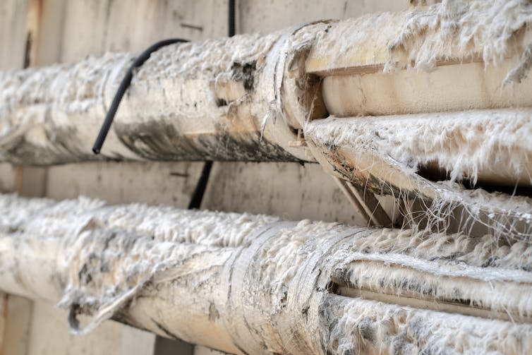 Pipes surrounded by asbestos insulation.