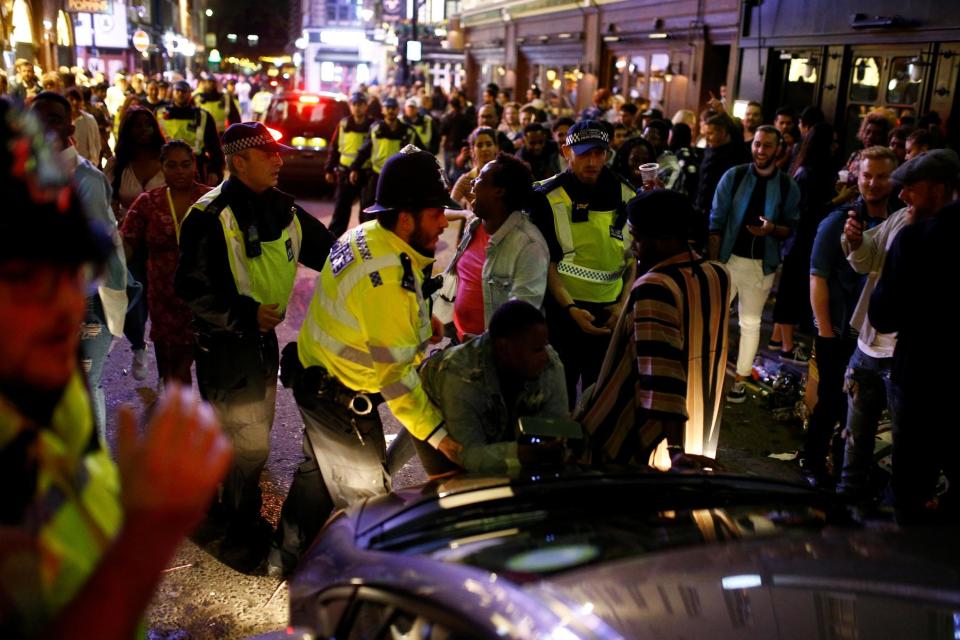 Police dealing with the crowds in Soho (REUTERS)