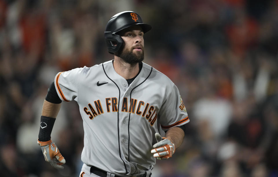 San Francisco Giants' Brandon Belt follows the flight of his three-run home run off Colorado Rockies starting pitcher Jon Gray in the fifth inning of a baseball game Saturday, Sept. 25, 2021, in Denver. (AP Photo/David Zalubowski)