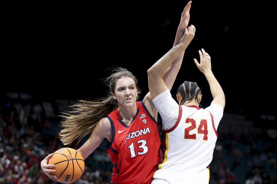Arizona guard Helena Pueyo (13) reacts while getting tied up with Southern California forward Kaitlyn Davis (24) during the second half of an NCAA college basketball game in the quarterfinal round of the Pac-12 tournament Thursday, March 7, 2024, in Las Vegas. (AP Photo/Ian Maule)