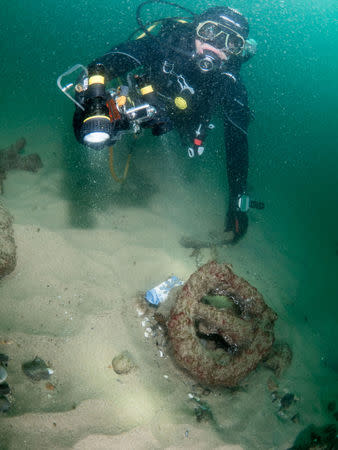 Divers are seen during the discovery of a centuries-old shipwreck, in Cascais in this handout photo released September 24, 2018. Augusto Salgado/Cascais City Hall/Handout via Reuters