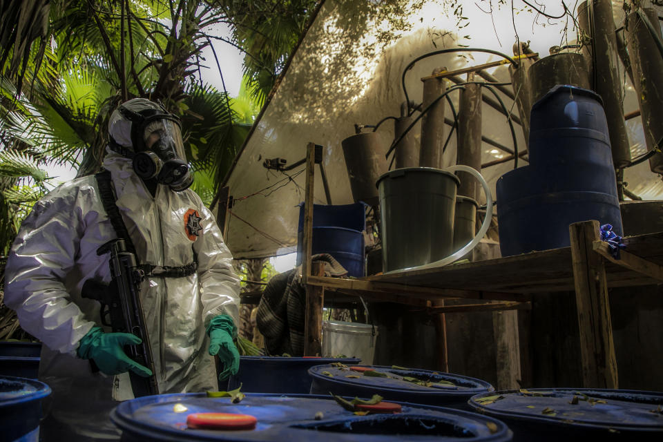 A Sinaloa's state police officer works during the dismantle of one of the three clandestine laboratories producers of synthetic drug, mainly methamphetamine in El Dorado, Sinaloa state, Mexico on June 4, 2019. (Photo by RASHIDE FRIAS / AFP)        (Photo credit should read RASHIDE FRIAS/AFP/Getty Images)