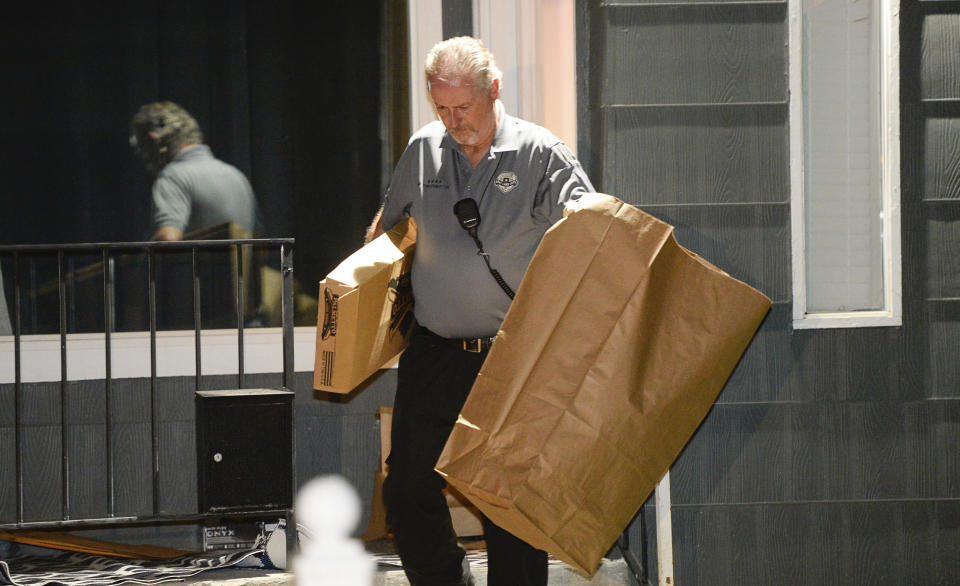 Police investigators remove multiple bags of evidence during their search of a home in Salt Lake City as part of the disappearance of University of Utah student MacKenzie Lueck that carried on into the early morning hours of Thursday, June 27, 2019. (Francisco Kjolseth/The Salt Lake Tribune via AP)