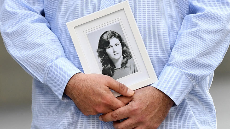 A family member holds a picture of murder victim Patricia Riggs outside the Supreme Court in Brisbane. Source: AAP