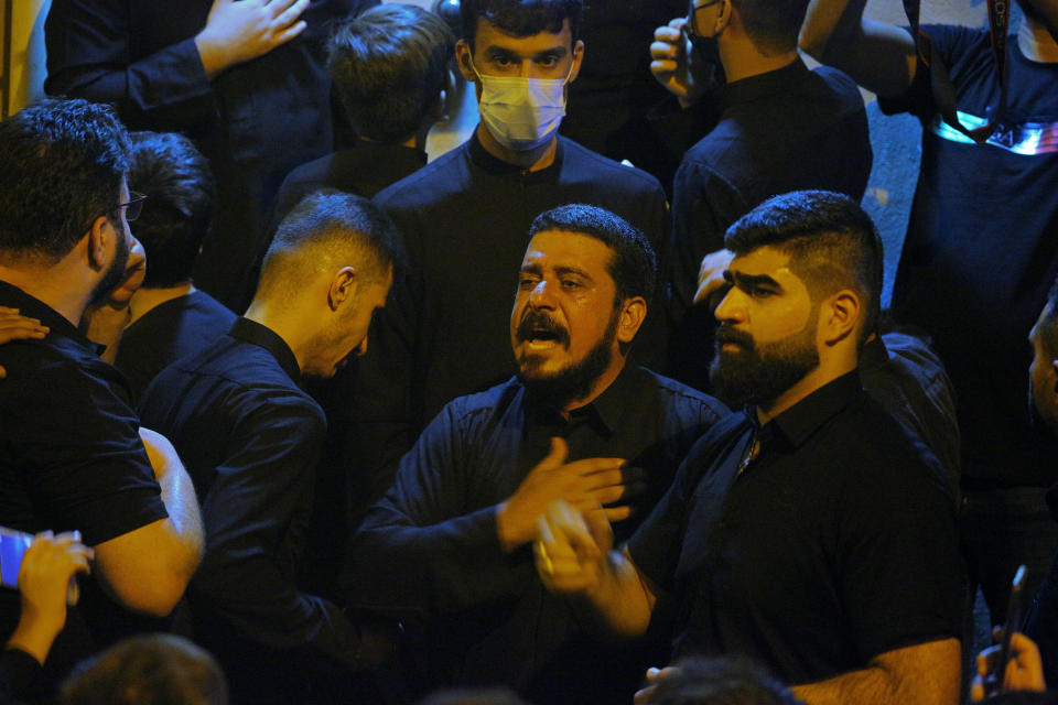 Mourners mourn outside the house of Grand Ayatollah Sayyid Mohammed Saeed al-Hakim in Najaf, Iraq, Friday, Sept. 3, 2021. Mohammed Saeed al-Hakim, one of Iraq's most senior and influential Muslim Shiite clerics, has died, members of his family said. He was 85. (AP Photo/Anmar Khalil)