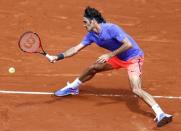 Roger Federer of Switzerland plays a shot to Marcel Granollers of Spain during their men's singles match at the French Open tennis tournament at the Roland Garros stadium in Paris, France, May 27, 2015. REUTERS/Vincent Kessler