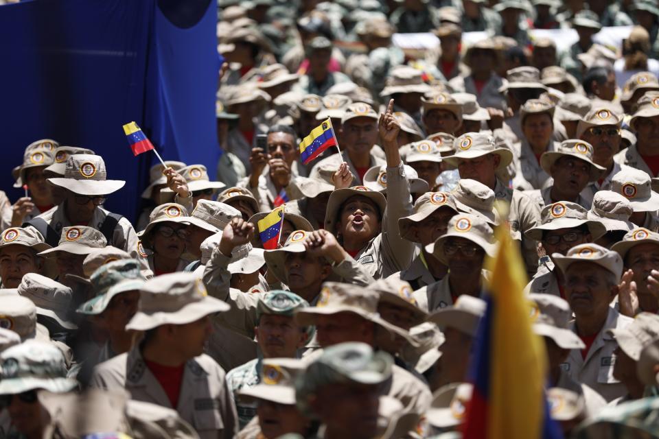 Members of the Bolivarian Militia gather for a rally marking the 22nd anniversary of the late President Hugo Chavez's return to power after a failed coup attempt, in Caracas, Venezuela, April 13, 2024. (AP Photo/Pedro Ramsee)
