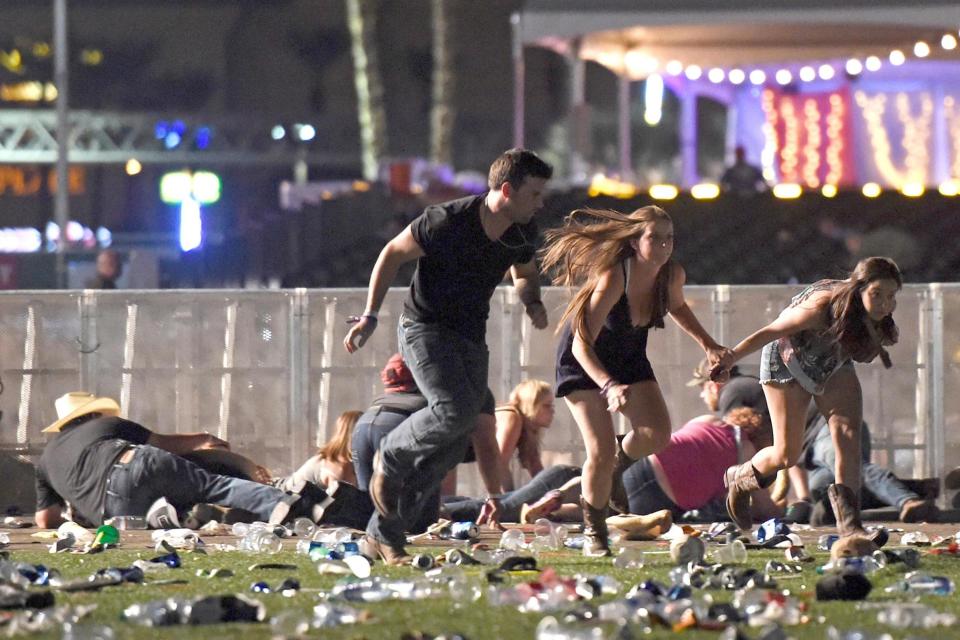Run for cover | revellers at the country music festival in Las Vegas flee for their lives after gunman Stephen Paddock opened fire on the crowd: David Becker/Getty Images