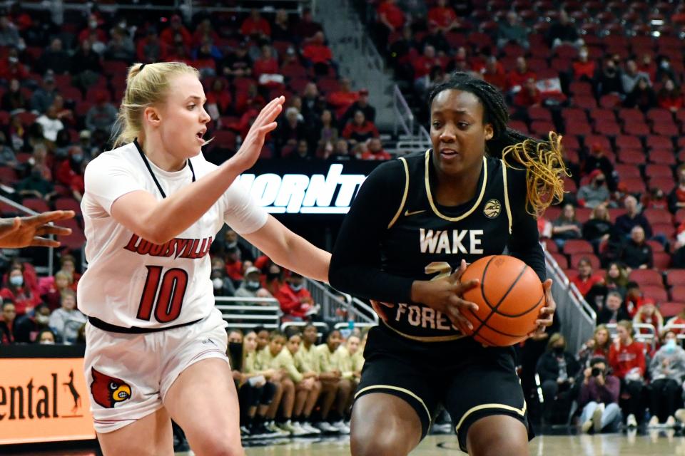 Wake Forest guard Elise Williams (21) attempts to drive past Louisville guard Hailey Van Lith (10) during the first half of an NCAA college basketball game in Louisville, Ky., Sunday, Jan. 23, 2022. (AP Photo/Timothy D. Easley)